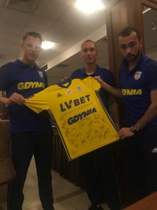 Piłkarze z drużyny Arka Gdynia wraz z licytowaną koszulką